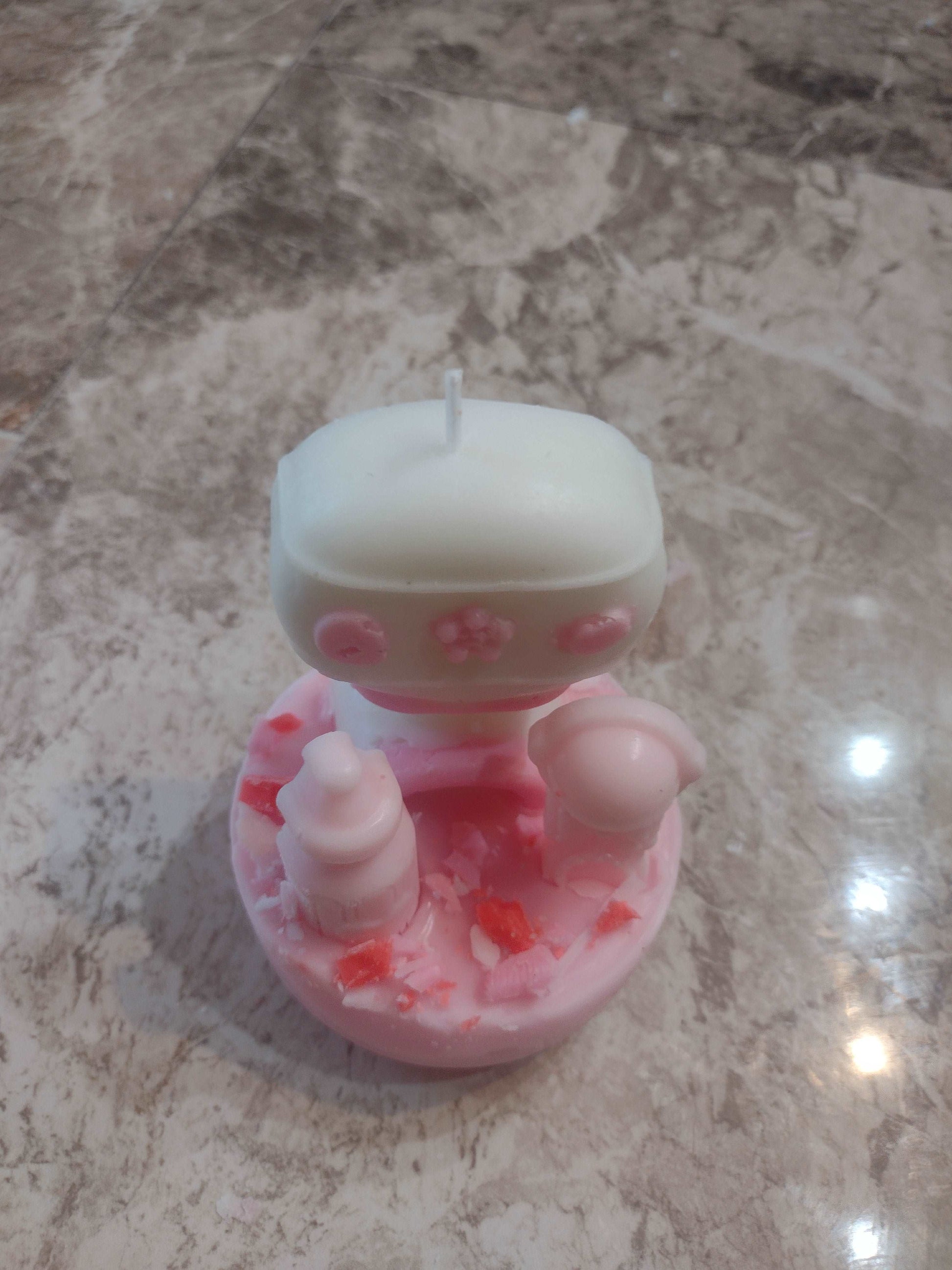 Eco-friendly Pink Bot Rattle Candle – sweet fragrance and decorative design.