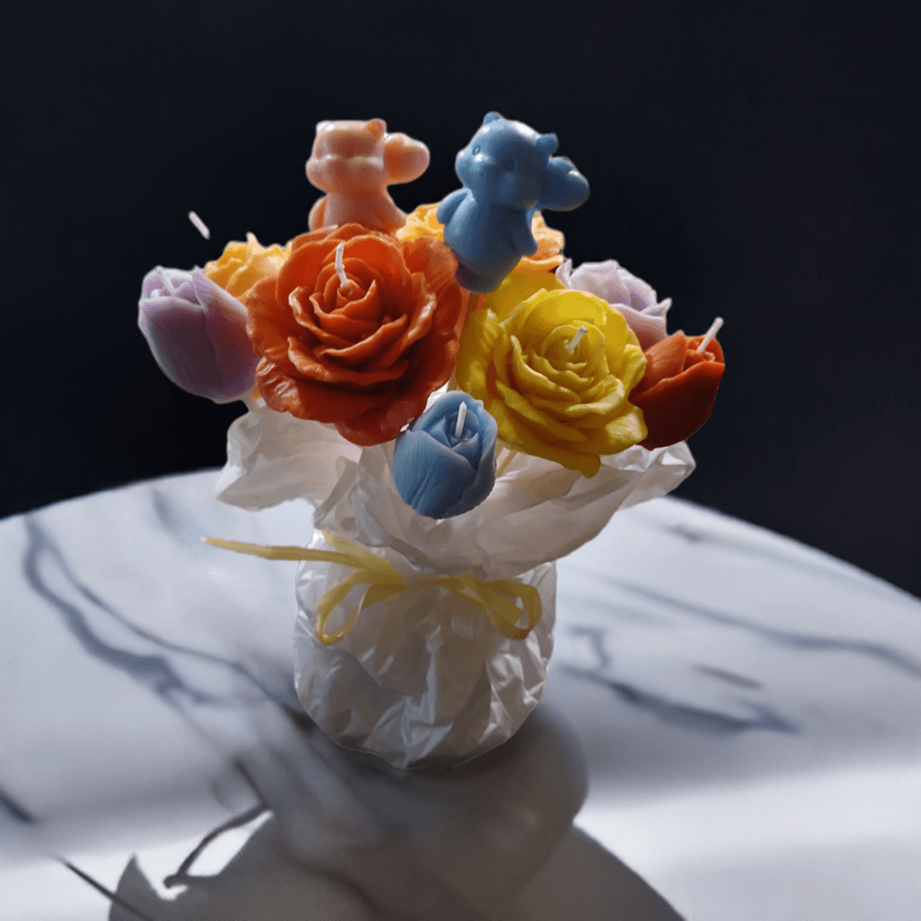 A beautiful handmade bouquet of soy wax flowers in vibrant colors, designed as a candle arrangement. The delicate petals are shaped to resemble real flowers, creating a stunning visual effect. The bouquet is infused with a fusion of calming scents.